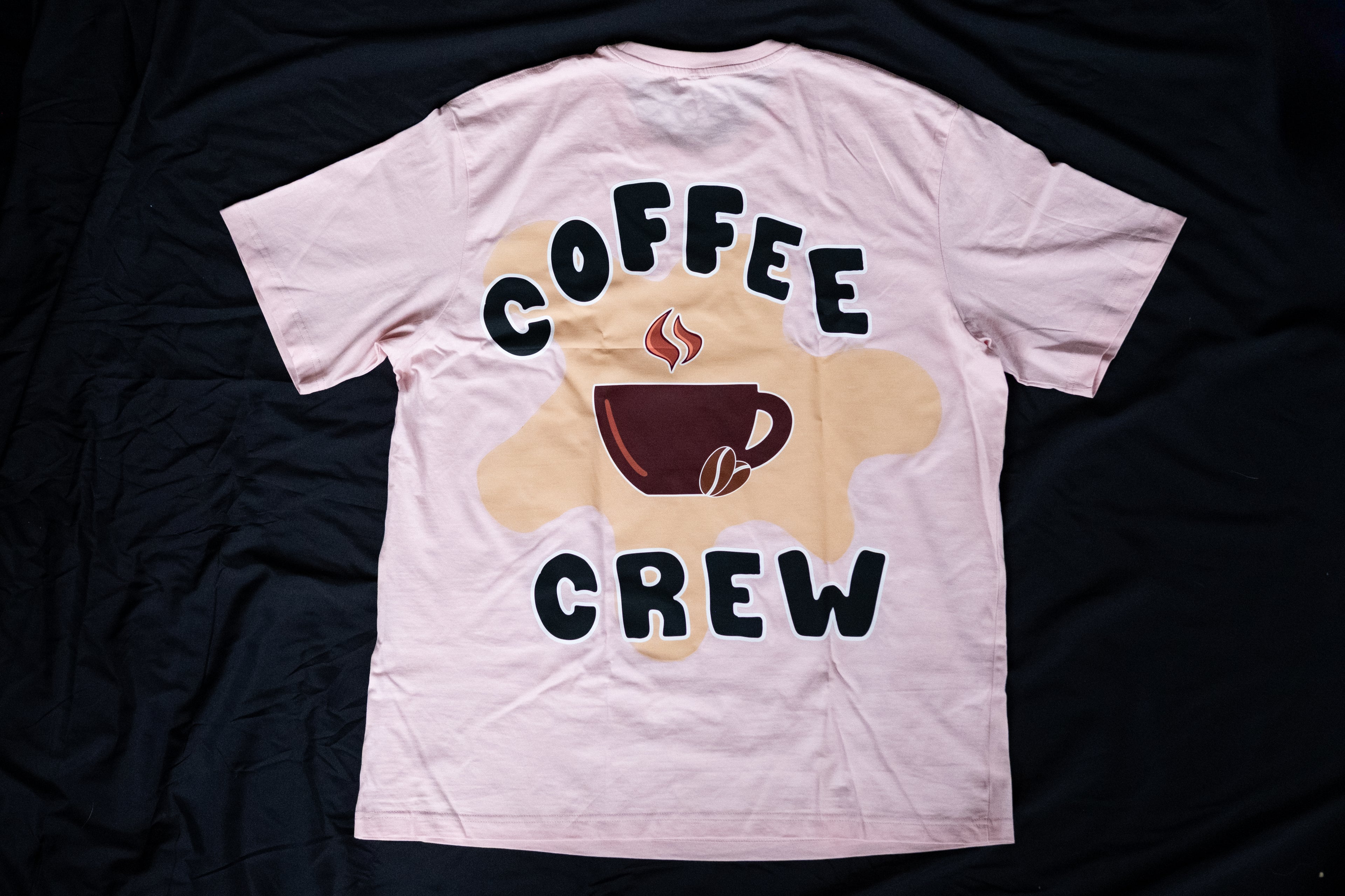 White t-shirt with 'Coffee Crew' graphic on a dark background