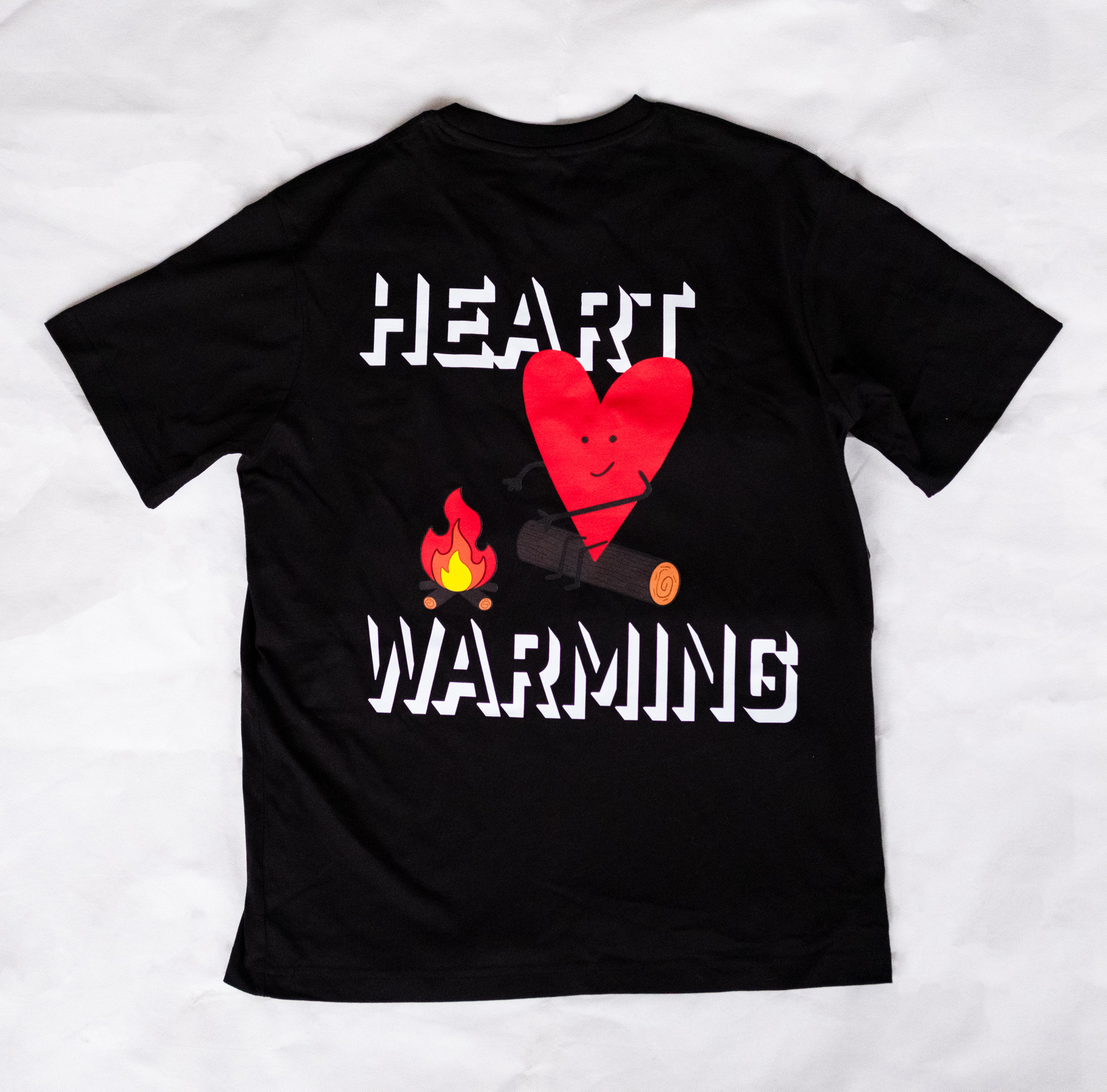 Black t-shirt with a red heart and campfire graphic and 'HEART WARMING' text on a white background