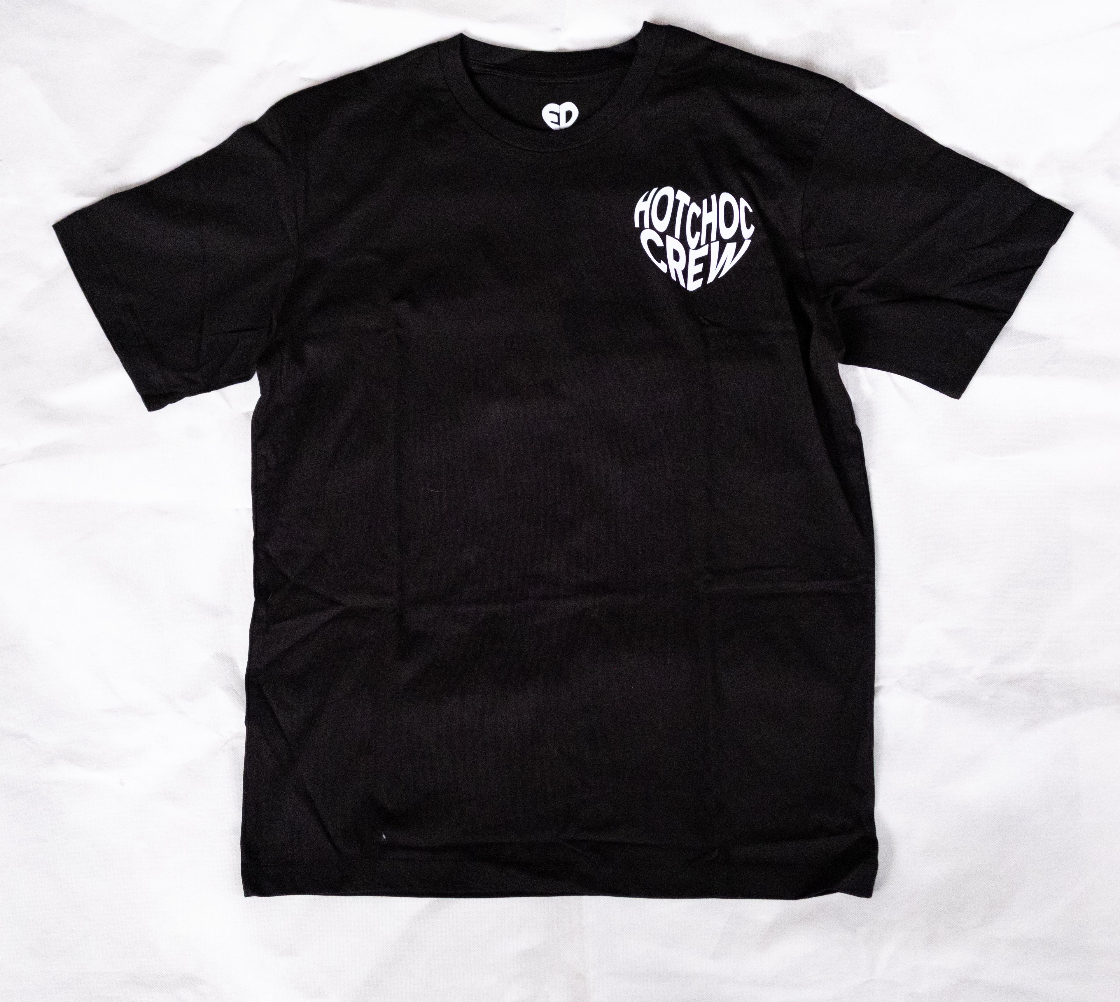 Black t-shirt with white logo on a white background