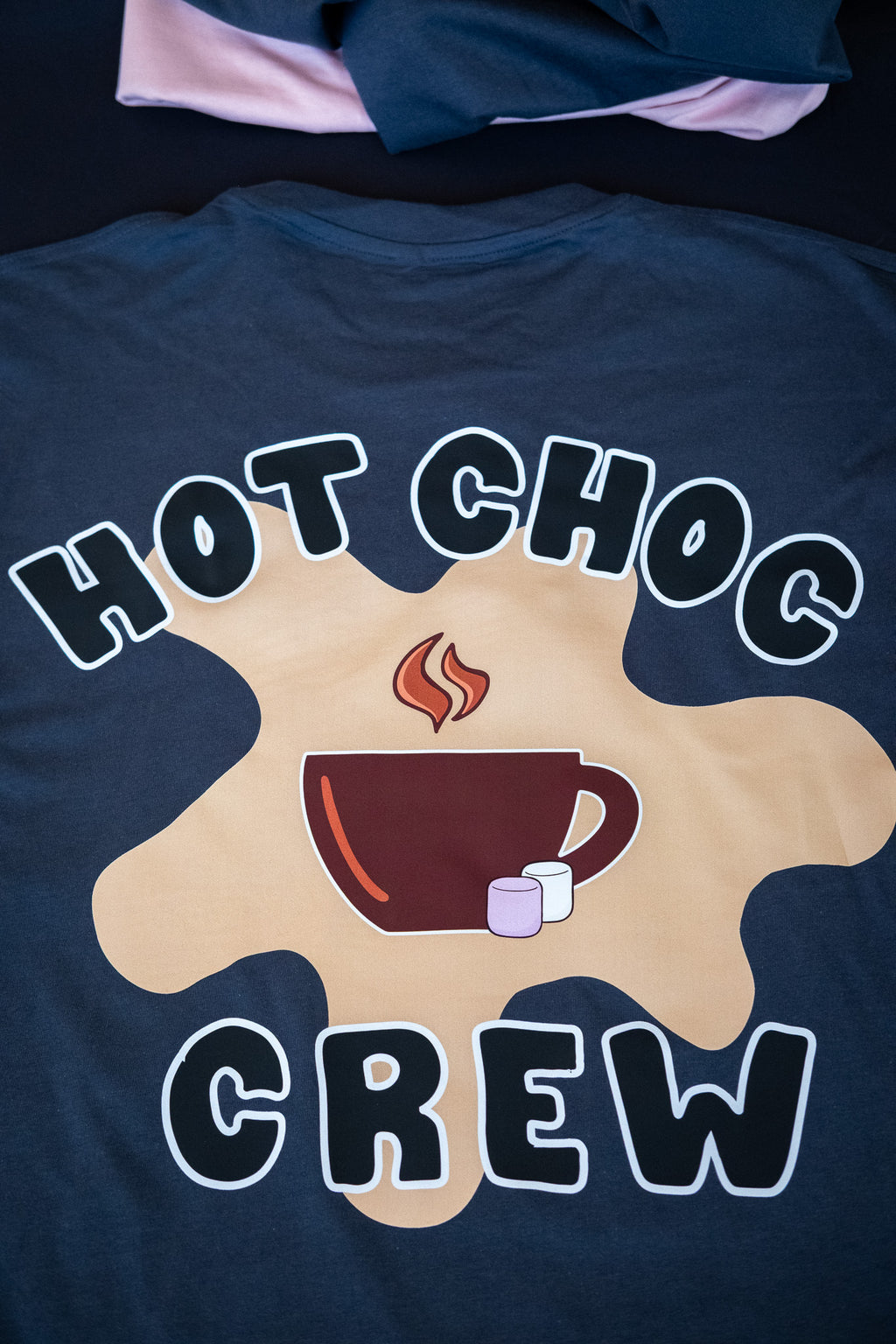 Navy blue t-shirt with 'Hot Choc Crew' design featuring a mug and marshmallows on a dark background.