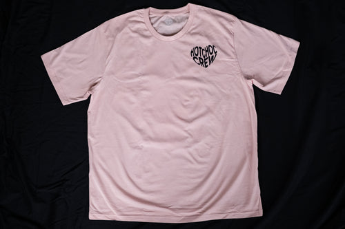 Pink t-shirt with a black logo on a black background