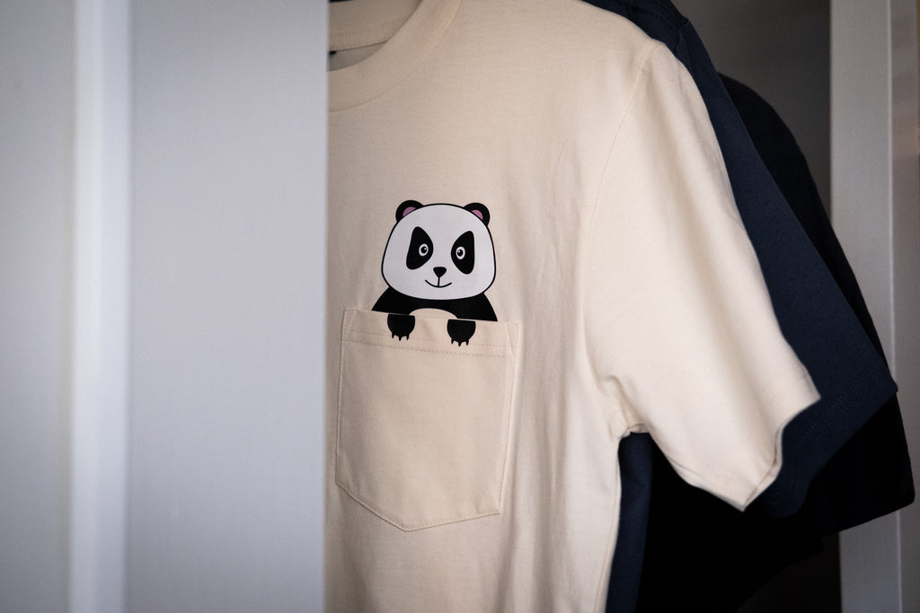 Beige t-shirt with a panda design on a white background